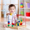 baby girl playing with educational toy in nursery