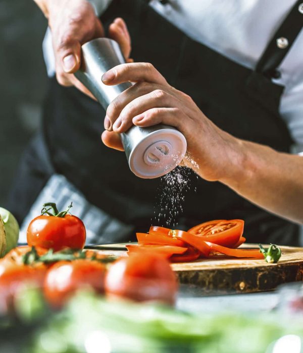 Chef cook preparing vegetables in his kitchen.
